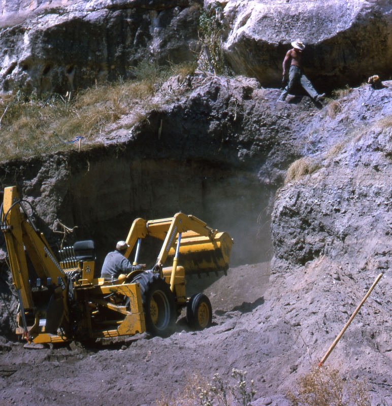 Harold Beall uses a backhoe to dig a trench