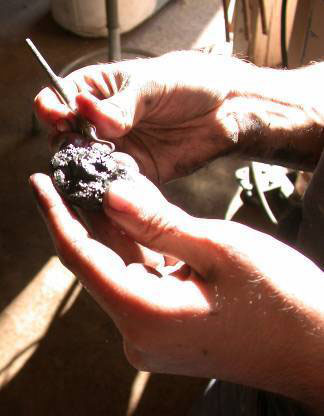 photo of a dentist's pick being used for detailed cleaning work on the artifacts