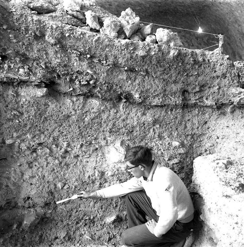 Roy Little points to Bone Bed 2 in profile of unit near Talus Cone. Photo by Dave Dibble.