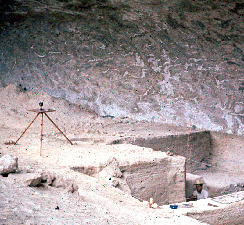 Plane table and alidade next to excavations in central part of Bonfire Shelter. Photo probably taken by Roy Little.