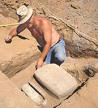 Large metate and three matching manos discovered by Gene Collins in an outside pit. These appear to be cached items, apparently hidden by someone who expected to return to the site. The metate weighs 80 pounds and is made of vesicular basalt hauled to the site from sources some 40 miles away.