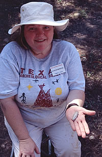 TAS member Sharon Menegaz from Tomball, Texas shows off a Hoxie dart point from the later deposits at Gault.