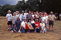 Field school supervisors and crew chiefs rally around the Explorer's Club expedition flag.