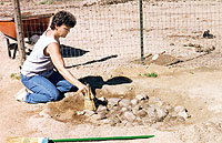 Charlotte Graham, in an early investigation of a hearth found on her property. The first artifacts were found by her horse!" Photo by Gene Schaffner.