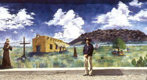 photo of scattered houses of Mexican community on ridge above green fields