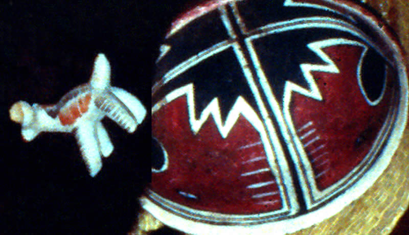 a painted black and red bowl and a painted dog figurine