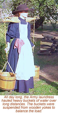 photo of women carrying buckets of water