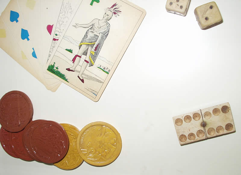 photo of antique poker cards, chips and dice