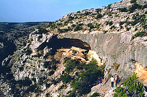 archeologists make their way to a rockshelter