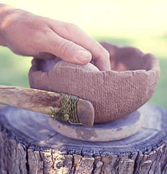 Photo of vessel being formed with cord-wrapped paddle